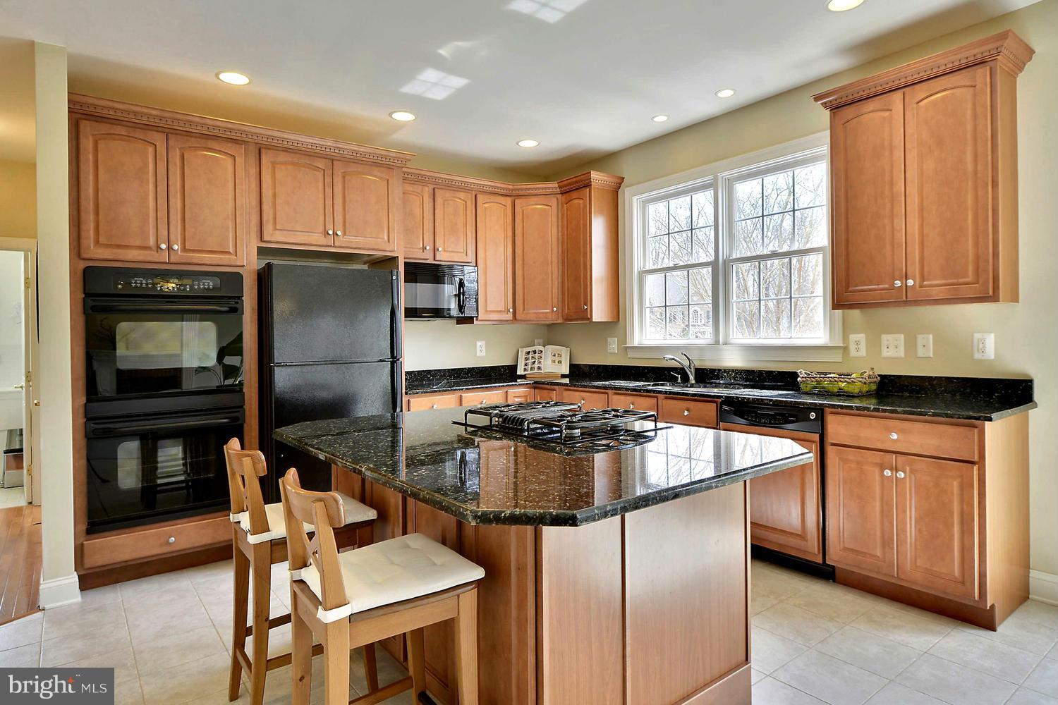 505 Tremont Circle Annapolis, MD 21409 - Photo 17 of 30 a kitchen with a refrigerator a stove and a cabinets