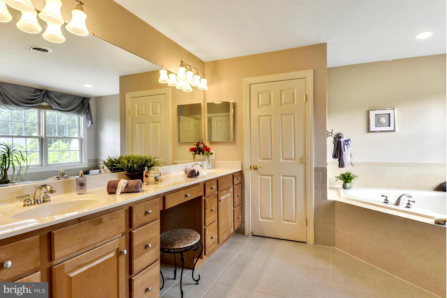 505 Tremont Circle Annapolis, MD 21409 - Photo 25 of 30 a spacious bathroom with a double vanity sink a mirror and a bathtub
