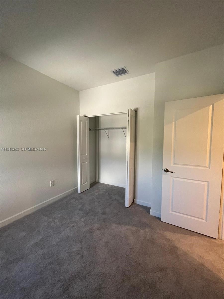 12908 Southwest 233rd Terrace, Unit 12908 Homestead, FL 33032 - Photo 14 of 23 an empty room with closet area