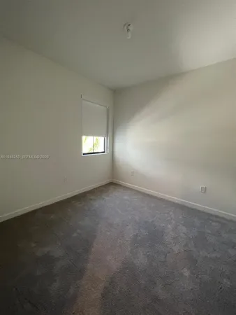 a large kitchen with a large counter top stainless steel appliances and cabinets