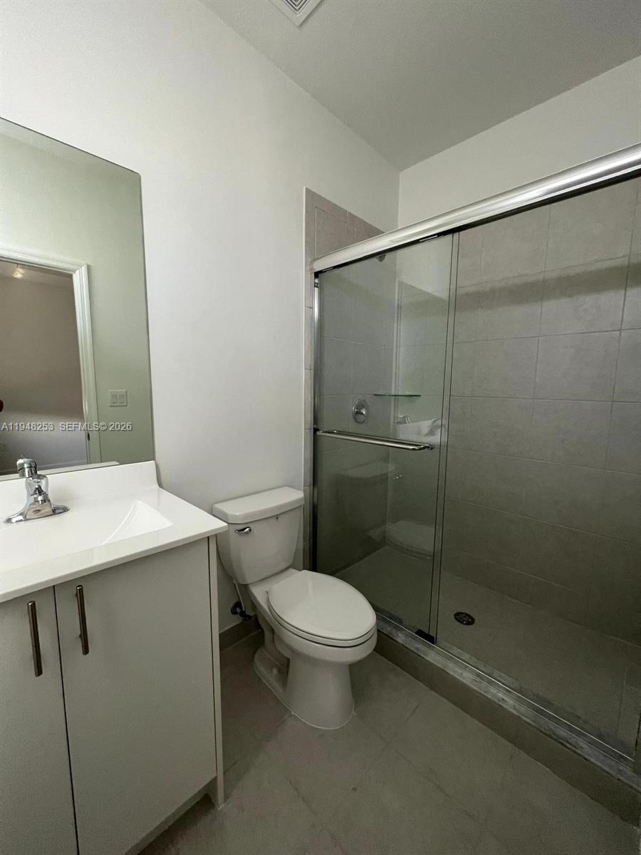 12908 Southwest 233rd Terrace, Unit 12908 Homestead, FL 33032 - Photo 17 of 23 a bathroom with a sink toilet and shower