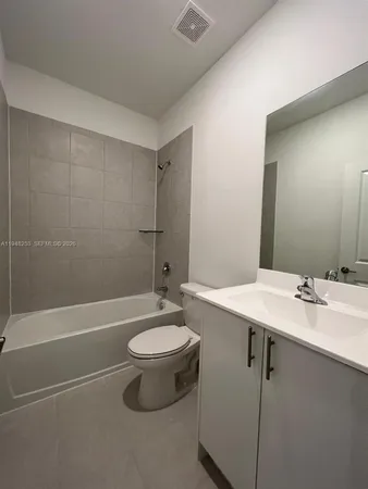a kitchen with stainless steel appliances a refrigerator sink and cabinets