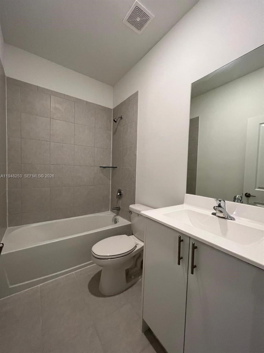 12908 Southwest 233rd Terrace, Unit 12908 Homestead, FL 33032 - Photo 20 of 23 a bathroom with a sink a toilet and shower