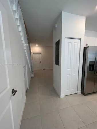 a view of a refrigerator in kitchen and entryway