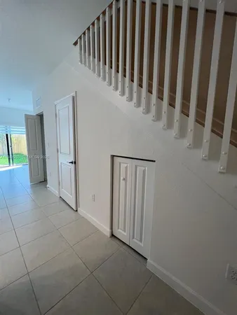 a view of a hallway with entryway door