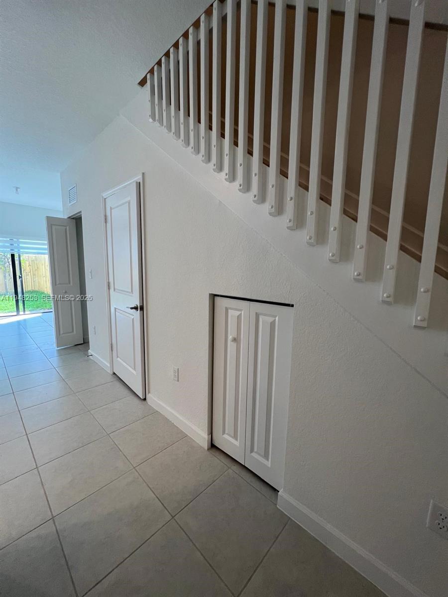 12908 Southwest 233rd Terrace, Unit 12908 Homestead, FL 33032 - Photo 7 of 23 a view of a hallway with entryway door
