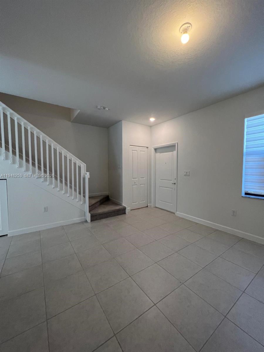12908 Southwest 233rd Terrace, Unit 12908 Homestead, FL 33032 - Photo 8 of 23 a view of an empty room