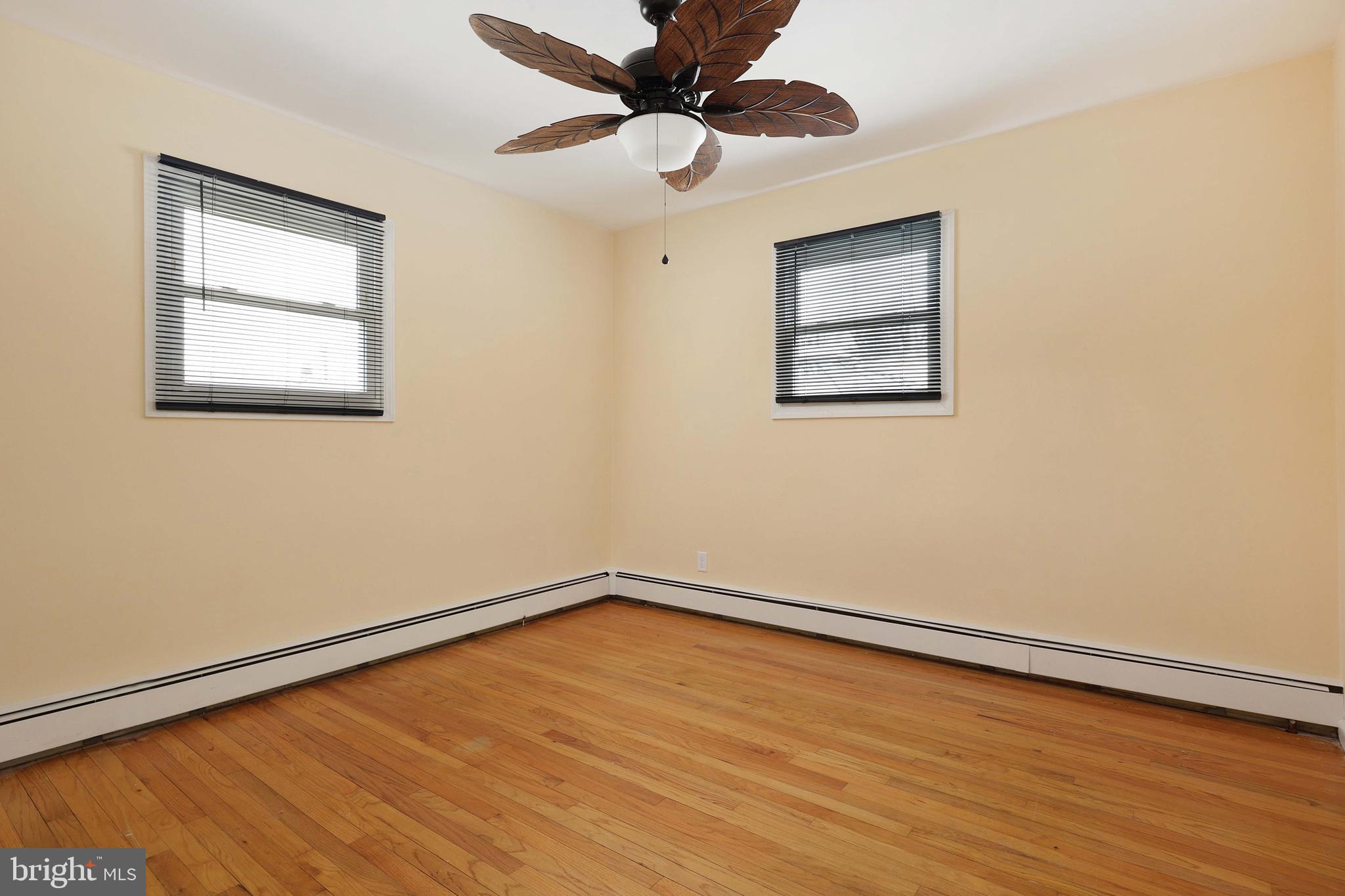 105 Kentucky Avenue Hamilton, NJ 08619 - Photo 13 of 29 an empty room with a window and a ceiling fan