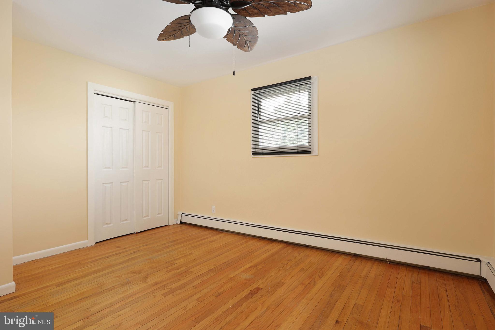 105 Kentucky Avenue Hamilton, NJ 08619 - Photo 14 of 29 an empty room with wooden floor fan and windows