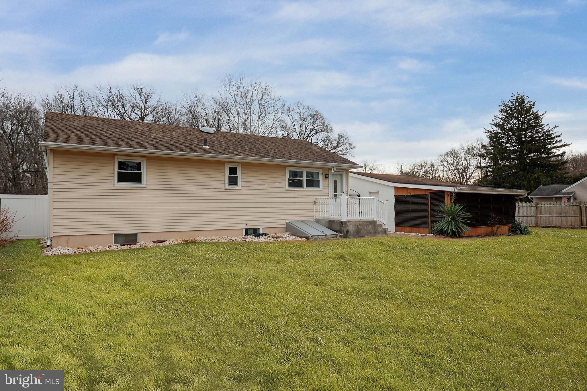 105 Kentucky Avenue Hamilton, NJ 08619 - Photo 23 of 29 a backyard of a house with plants and wooden fence