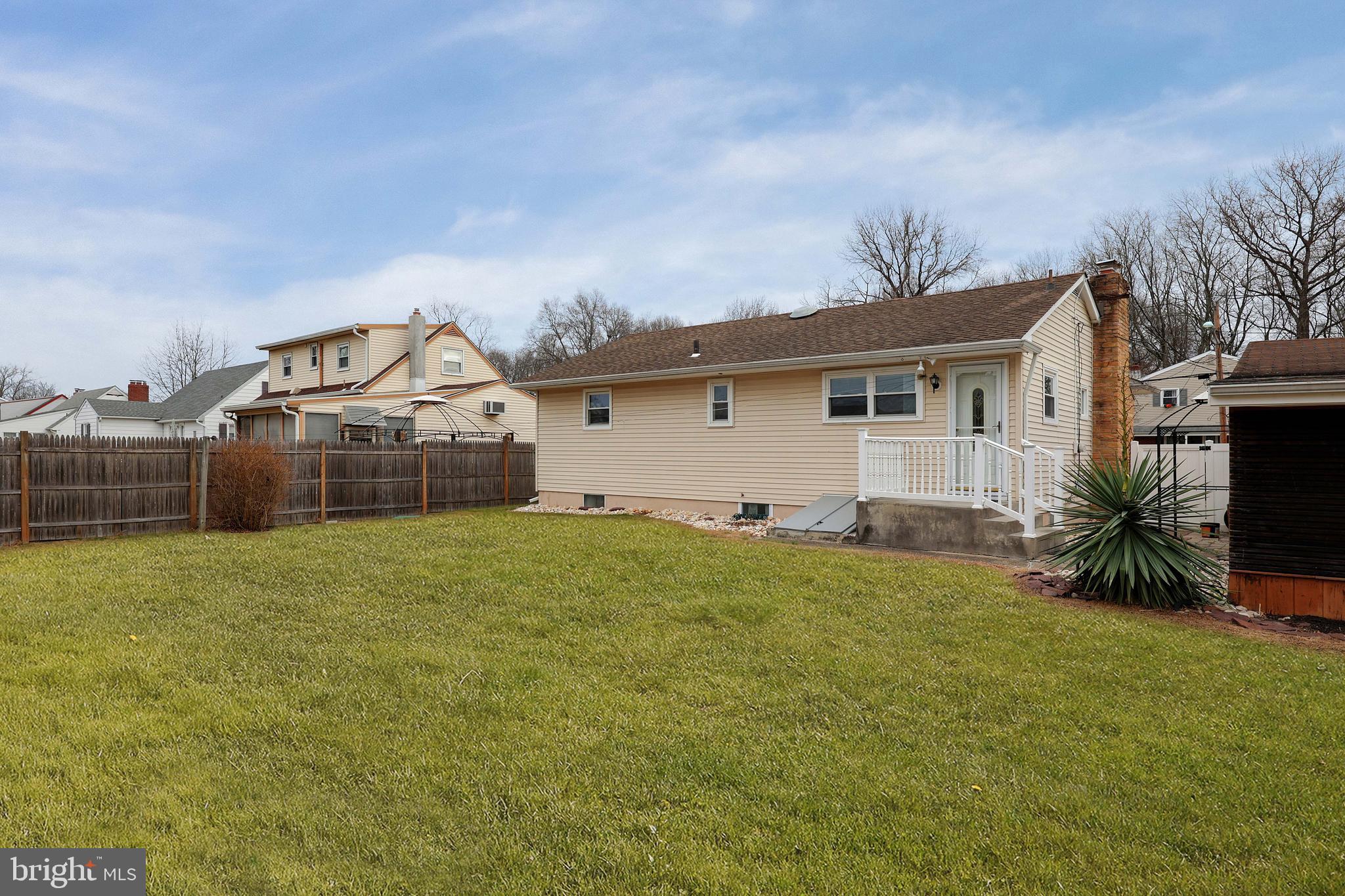 105 Kentucky Avenue Hamilton, NJ 08619 - Photo 24 of 29 a front view of a house with a yard and garage