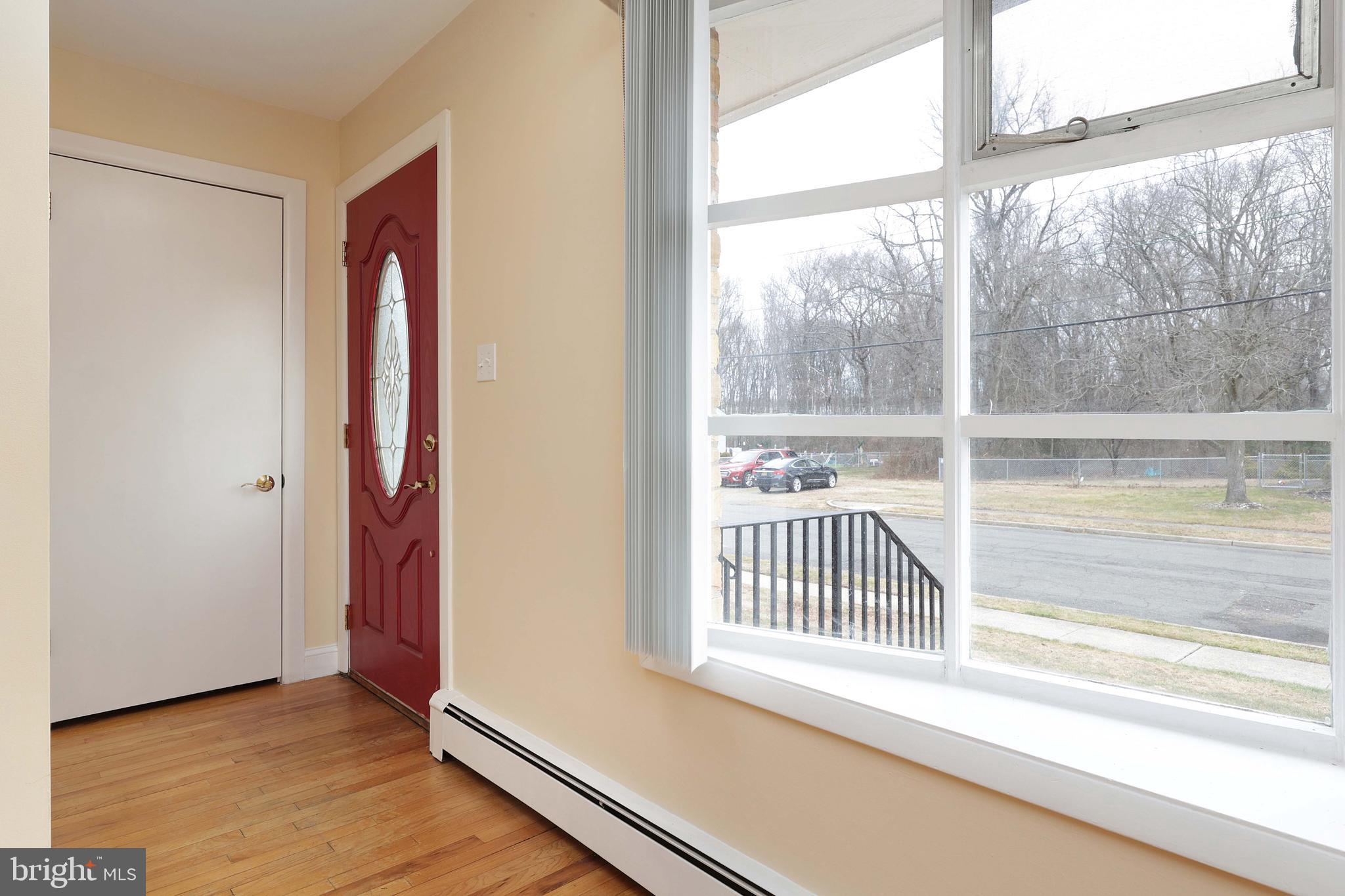 105 Kentucky Avenue Hamilton, NJ 08619 - Photo 5 of 29 an empty room with wooden floor and windows