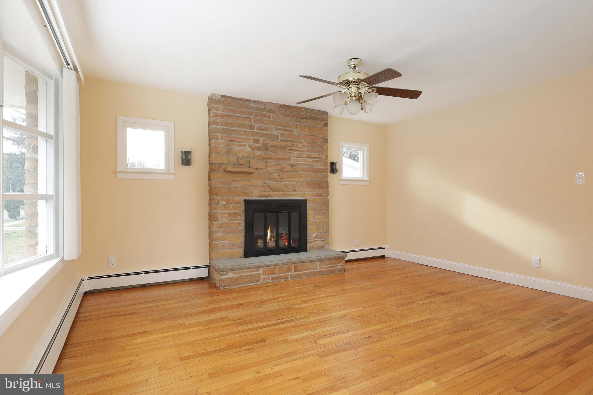105 Kentucky Avenue Hamilton, NJ 08619 - Photo 7 of 29 a view of an empty room with a fireplace and a window