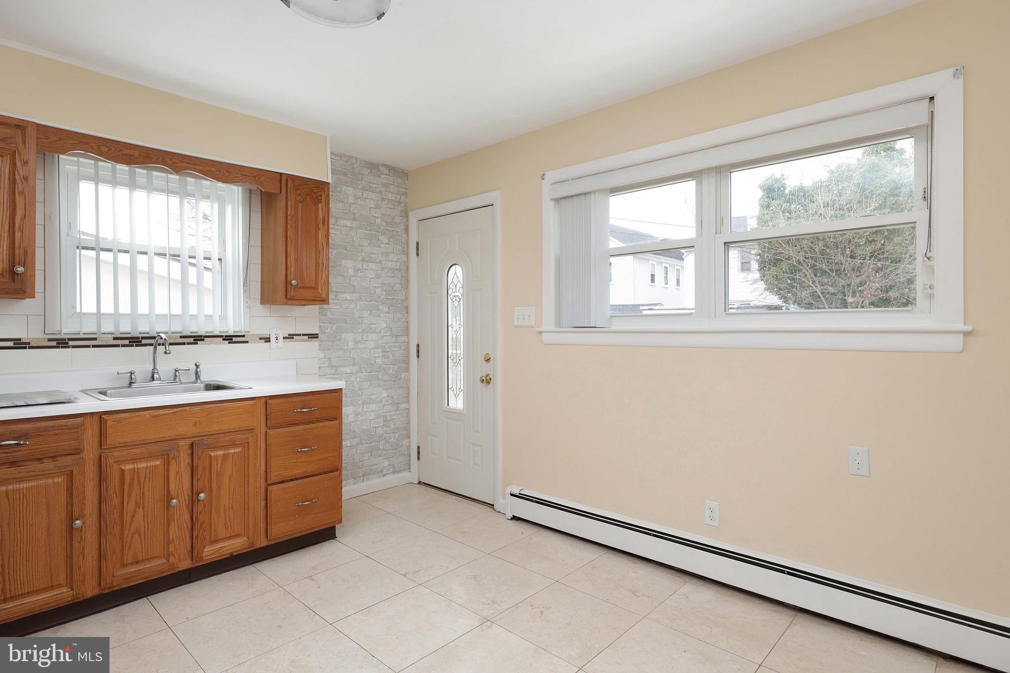 105 Kentucky Avenue Hamilton, NJ 08619 - Photo 9 of 29 a bathroom with a sink mirror and a bathtub