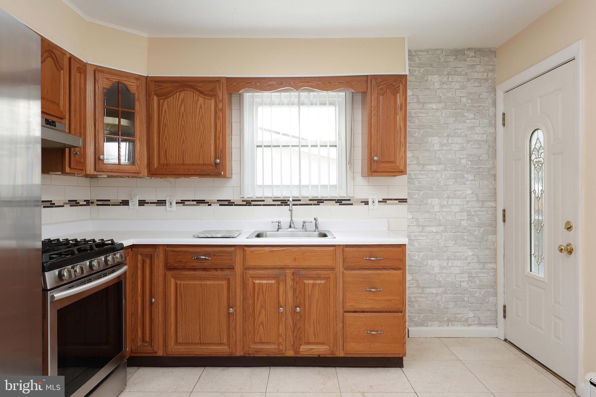 105 Kentucky Avenue Hamilton, NJ 08619 - Photo 10 of 29 a kitchen with granite countertop a sink and a stove