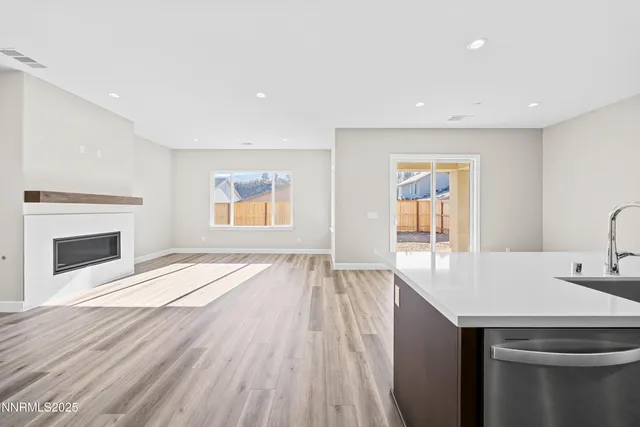 a kitchen with kitchen island stainless steel appliances a sink stove and refrigerator