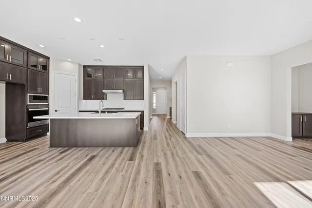 a kitchen with granite countertop a stove and a sink
