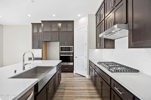 a large kitchen with kitchen island a sink stainless steel appliances and cabinets