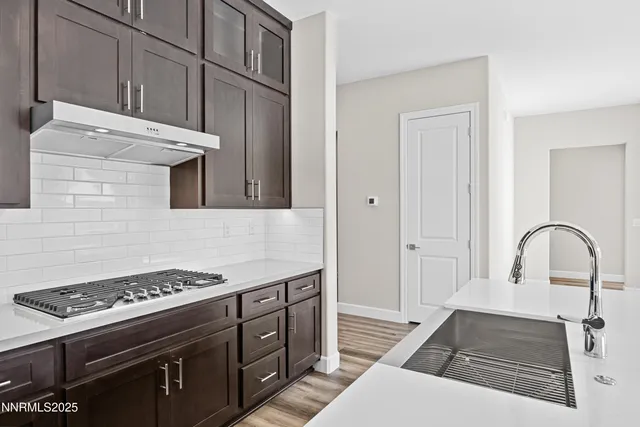 a view of empty room with wooden floor and fireplace
