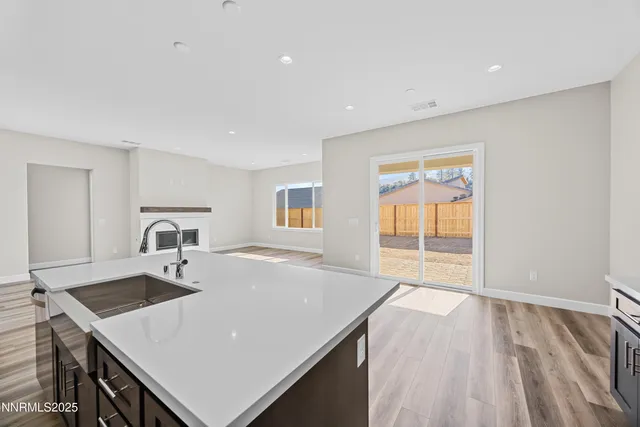 a view of an empty room with a fireplace and a window