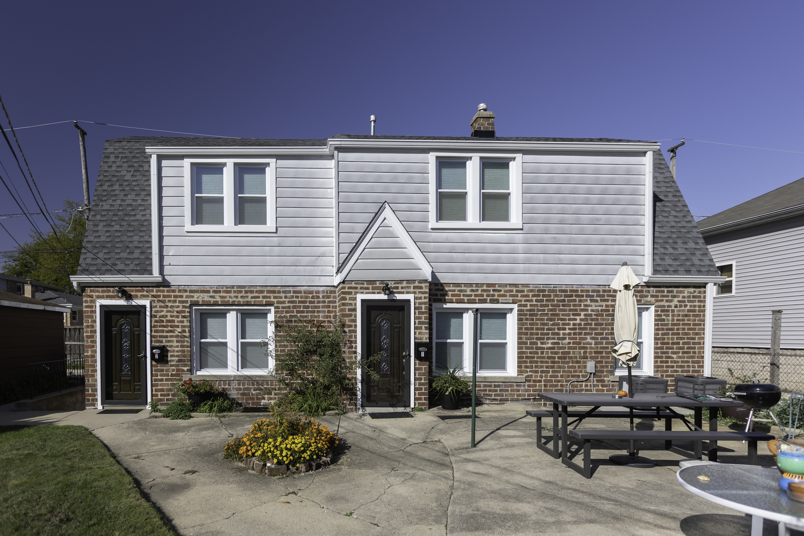a front view of a house with sitting area