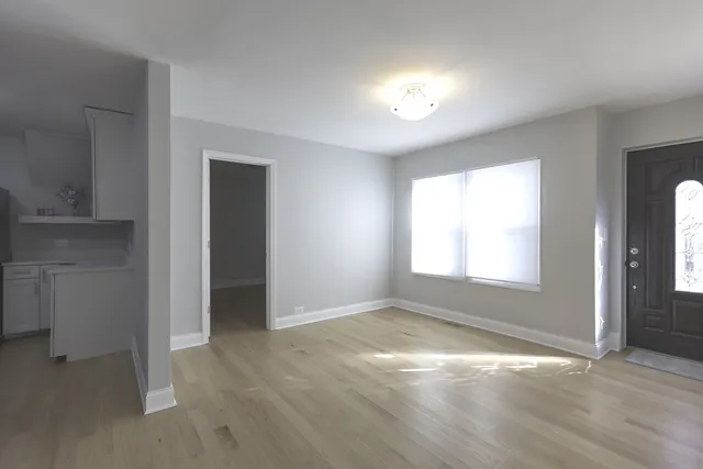 an empty room with windows and closet