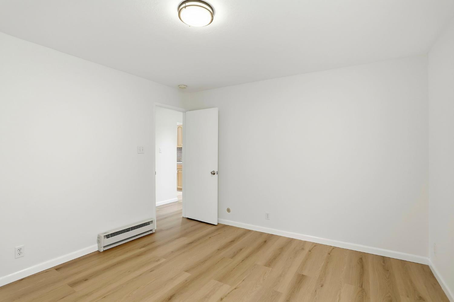 9005 Alcosta Boulevard, Unit 215 San Ramon, CA 94583 - Photo 16 of 30 a view of an empty room and wooden floor