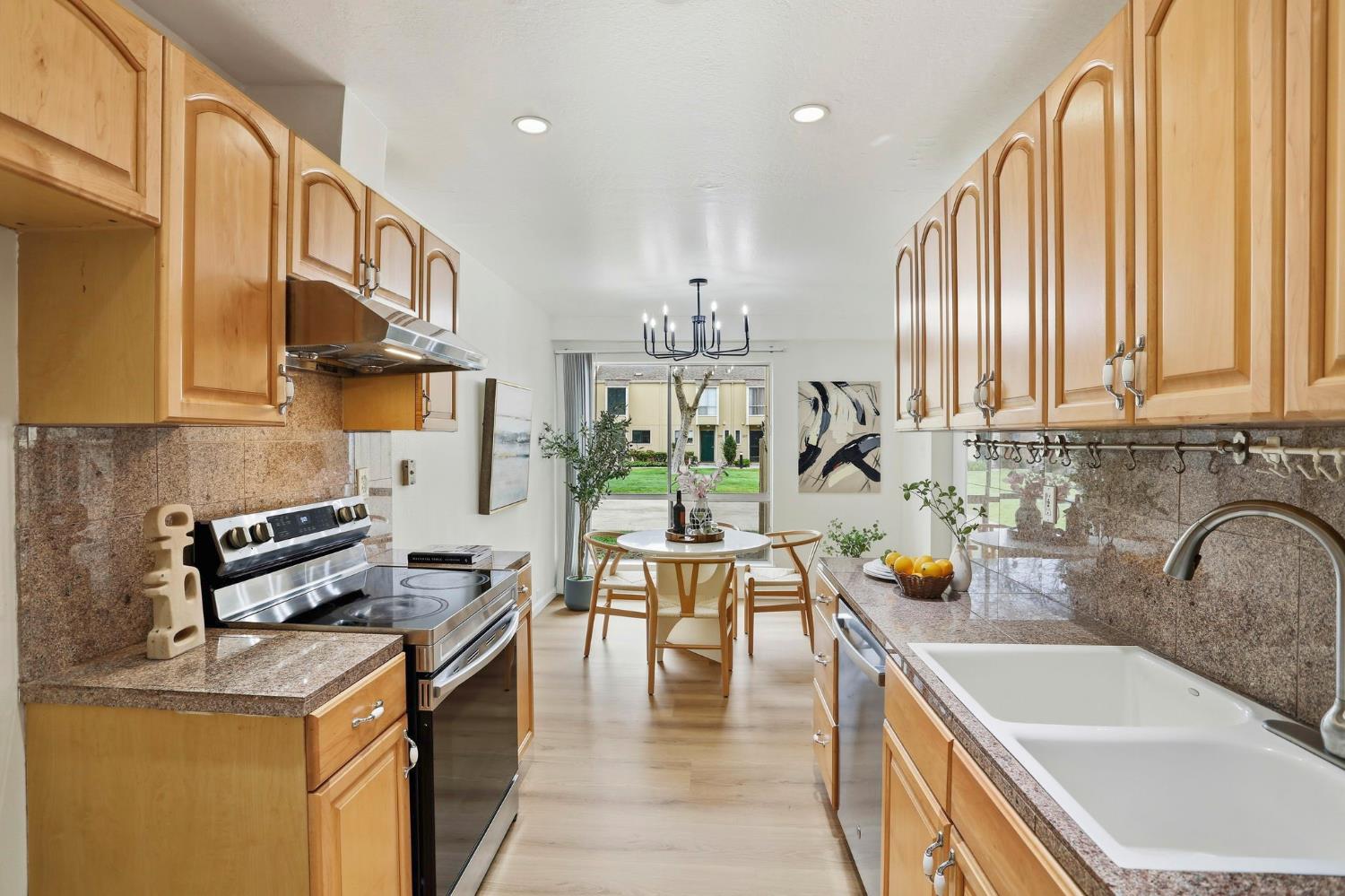 9005 Alcosta Boulevard, Unit 215 San Ramon, CA 94583 - Photo 3 of 30 a kitchen with stainless steel appliances granite countertop a sink a stove and a wooden floors
