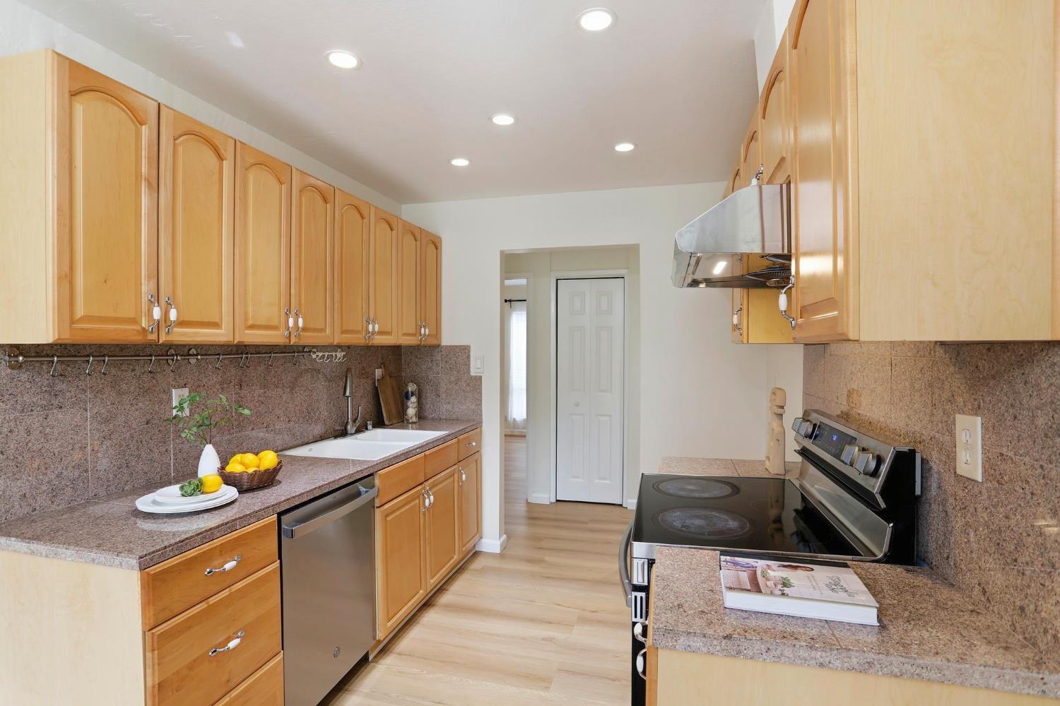 9005 Alcosta Boulevard, Unit 215 San Ramon, CA 94583 - Photo 8 of 30 a kitchen with stainless steel appliances granite countertop a stove a sink and a refrigerator