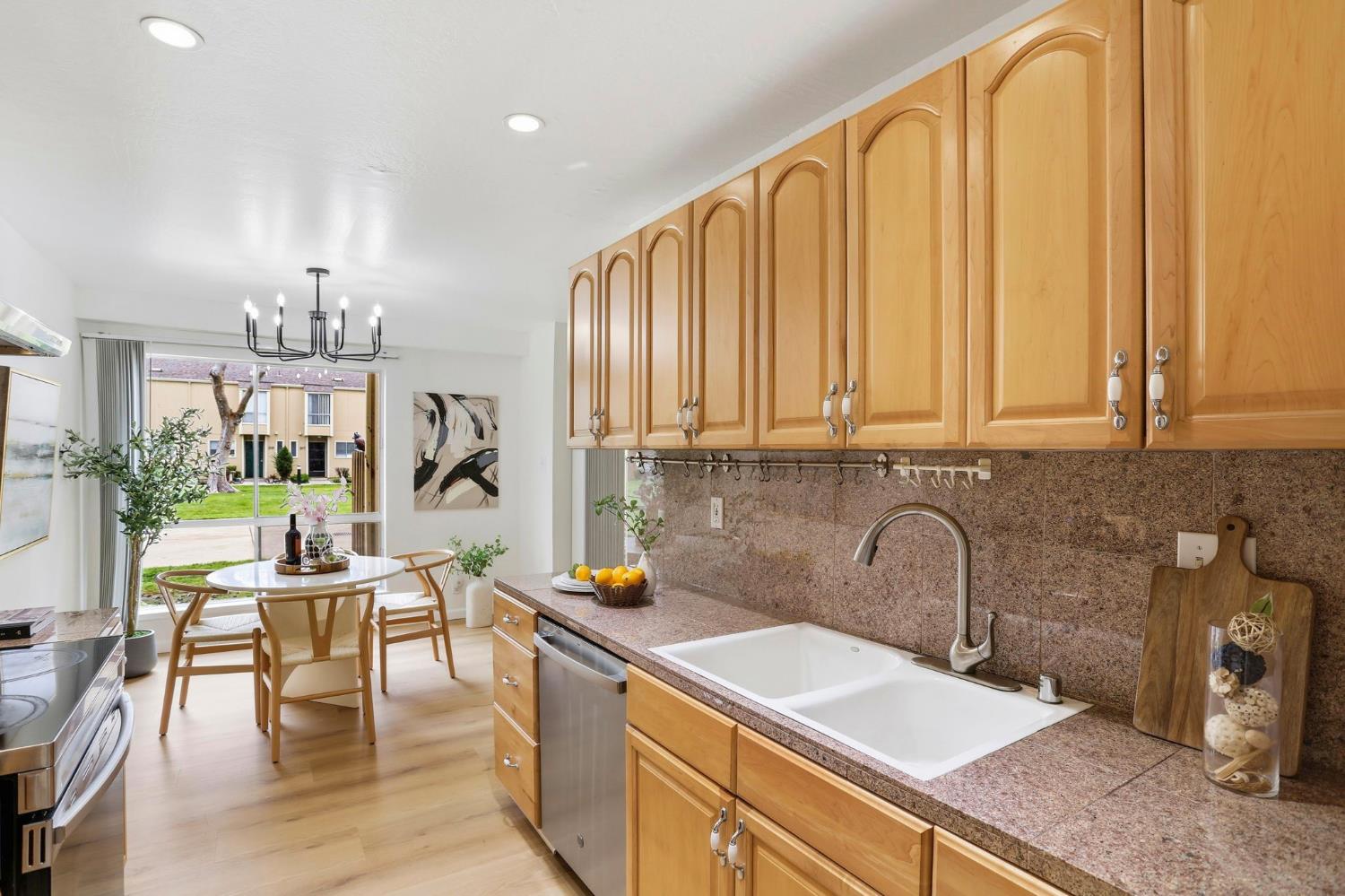 9005 Alcosta Boulevard, Unit 215 San Ramon, CA 94583 - Photo 9 of 30 a kitchen with stainless steel appliances granite countertop a sink dishwasher and cabinets with wooden floor