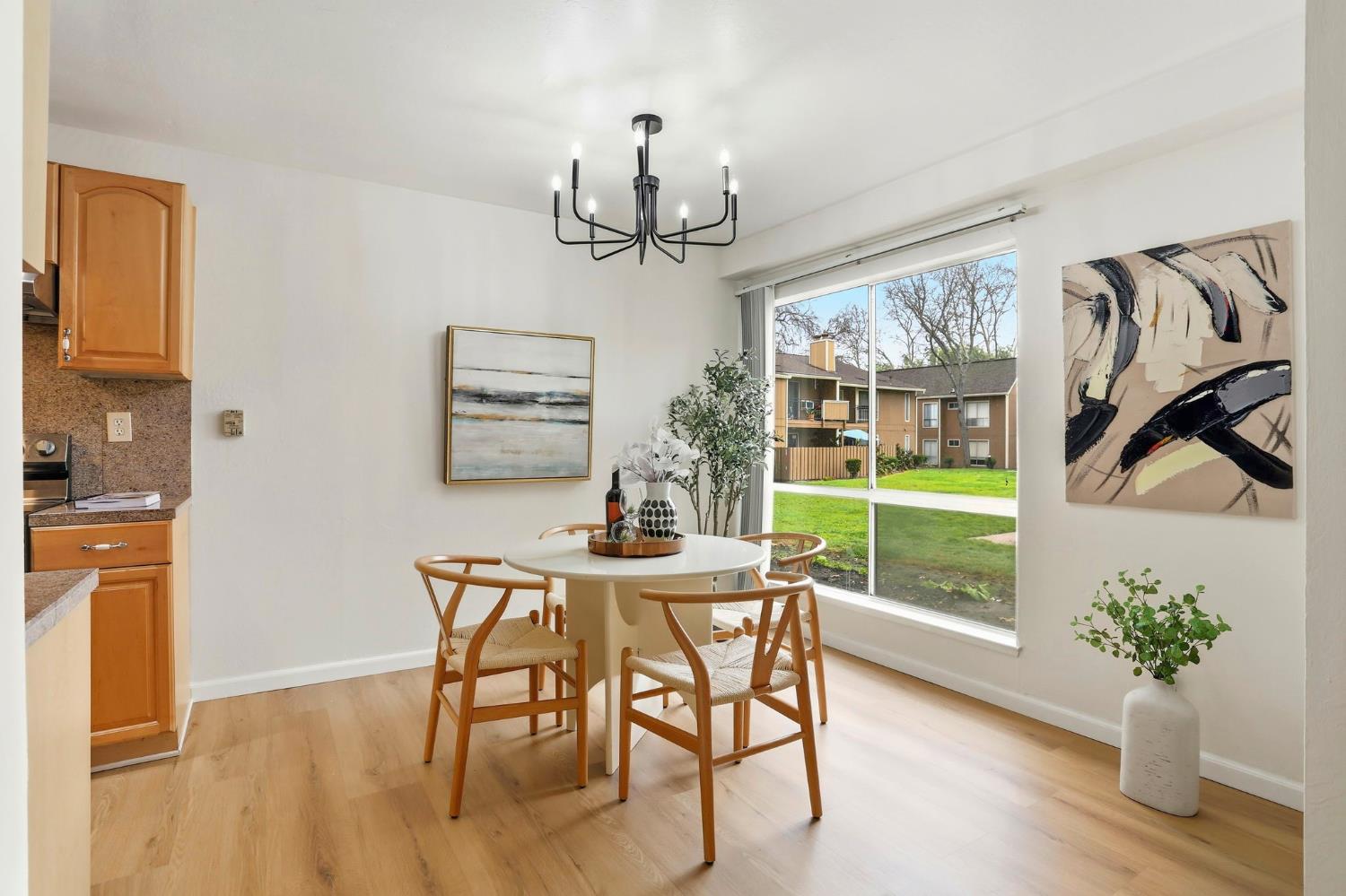 9005 Alcosta Boulevard, Unit 215 San Ramon, CA 94583 - Photo 10 of 30 a view of a dining room with furniture a chandelier and wooden floor