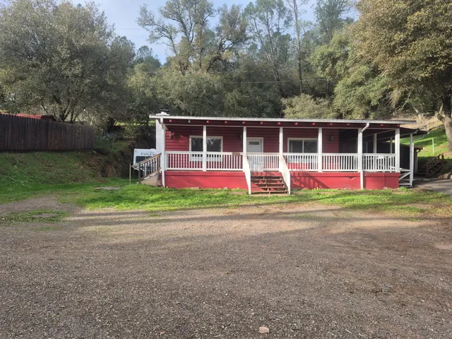 a front view of house with yard and trees