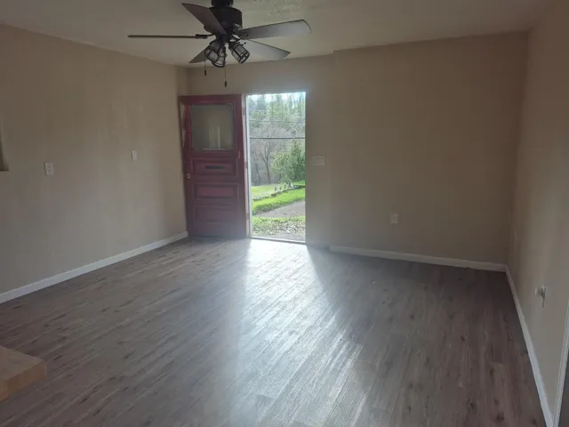 a kitchen with stainless steel appliances granite countertop a wooden floors a stove and a sink