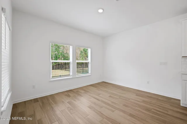 a view of large kitchen with kitchen island sink stainless steel appliances and cabinets