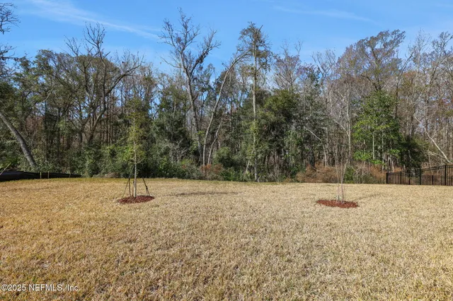 an aerial view of a house with outdoor space and a lake view