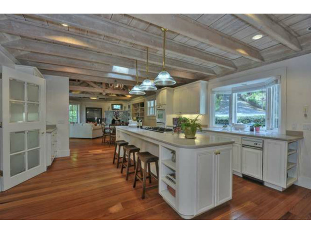 15670 Peach Hill Road Saratoga, CA 95070 - Photo 14 of 25 a kitchen with stainless steel appliances granite countertop a table chairs and wooden floors