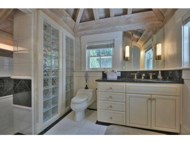 15670 Peach Hill Road Saratoga, CA 95070 - Photo 21 of 25 a bathroom with a toilet a sink and glass door