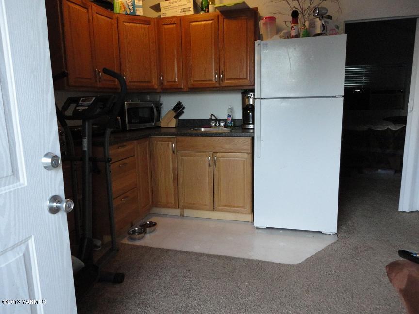 6408 Postma Road Yakima, WA 98901 - Photo 22 of 25 a kitchen with a refrigerator and cabinets
