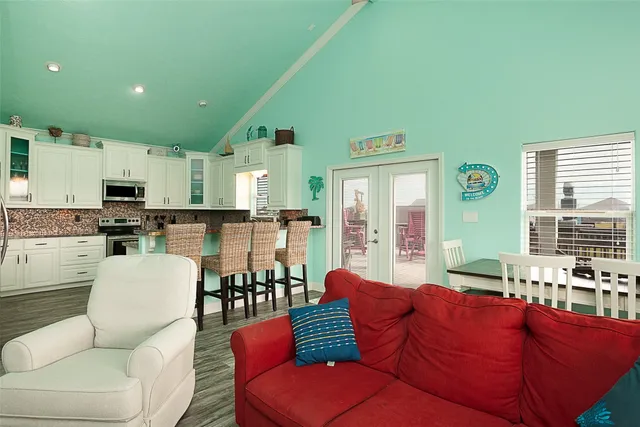 a living room with furniture and kitchen view