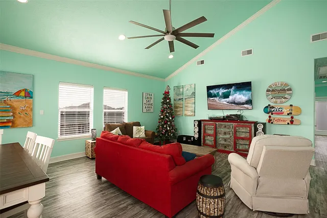 a living room with furniture ceiling fan and a window