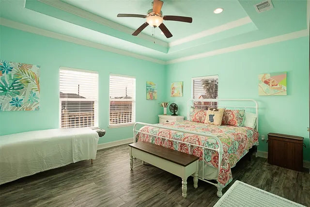 a bedroom with a bed a chandelier and a window