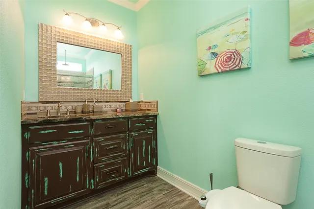 a bathroom with a toilet a sink and mirror