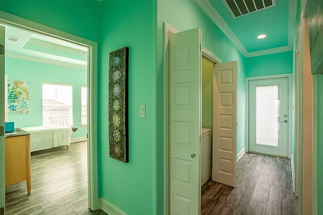 a view of hallway with livingroom and wooden floor