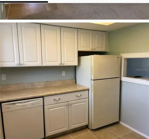 a view of a hallway with wooden floor and chandelier