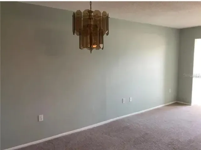 a white toilet sitting next to a white sink and vanity