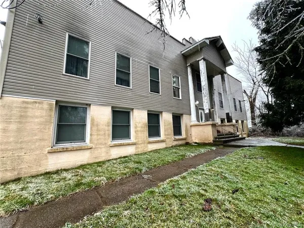 a front view of a house with a garden