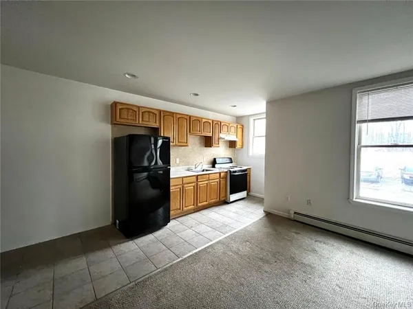 a kitchen with a refrigerator and a sink