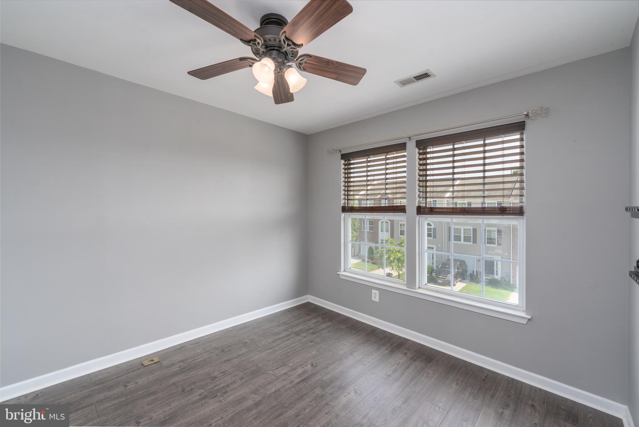 9903 Decatur Road Baltimore, MD 21220 - Photo 12 of 37 wooden floor in an empty room with a window