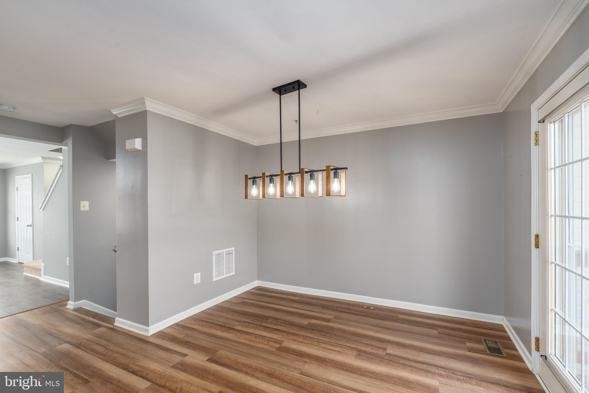 9903 Decatur Road Baltimore, MD 21220 - Photo 15 of 37 a view of an empty room with wooden floor and a window