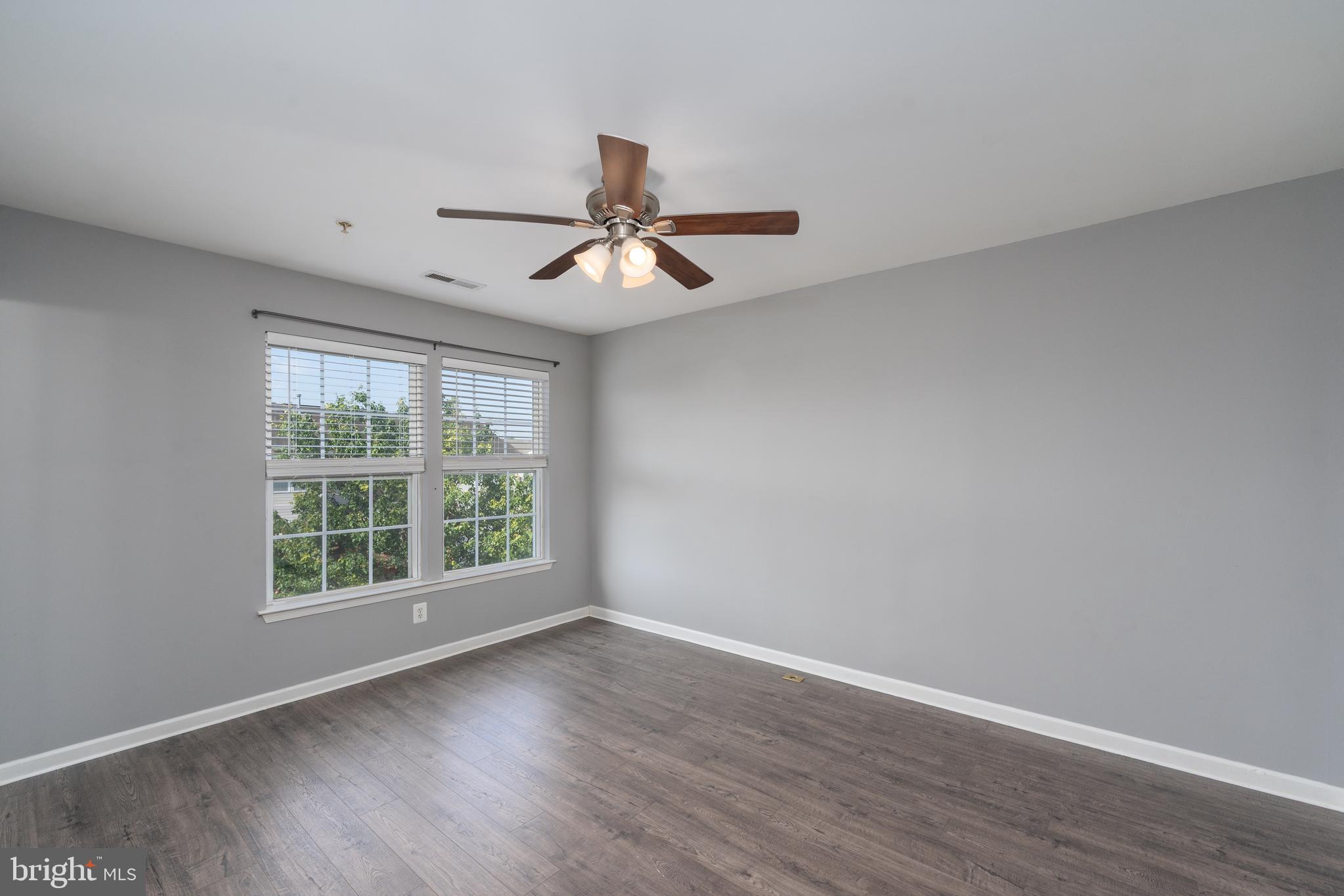 9903 Decatur Road Baltimore, MD 21220 - Photo 16 of 37 a view of an empty room with window and wooden floor
